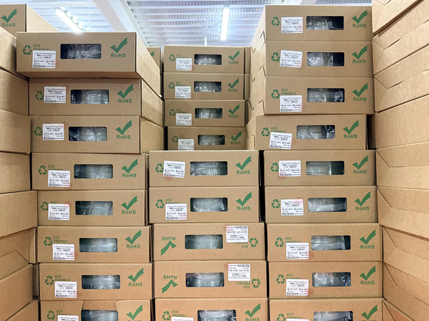Orange and green 3D printer filament spools